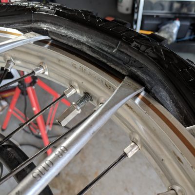 Pull small tire section over rim lock
