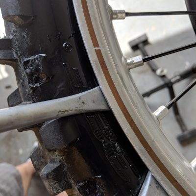 Tire iron inserted past lip of tire bead