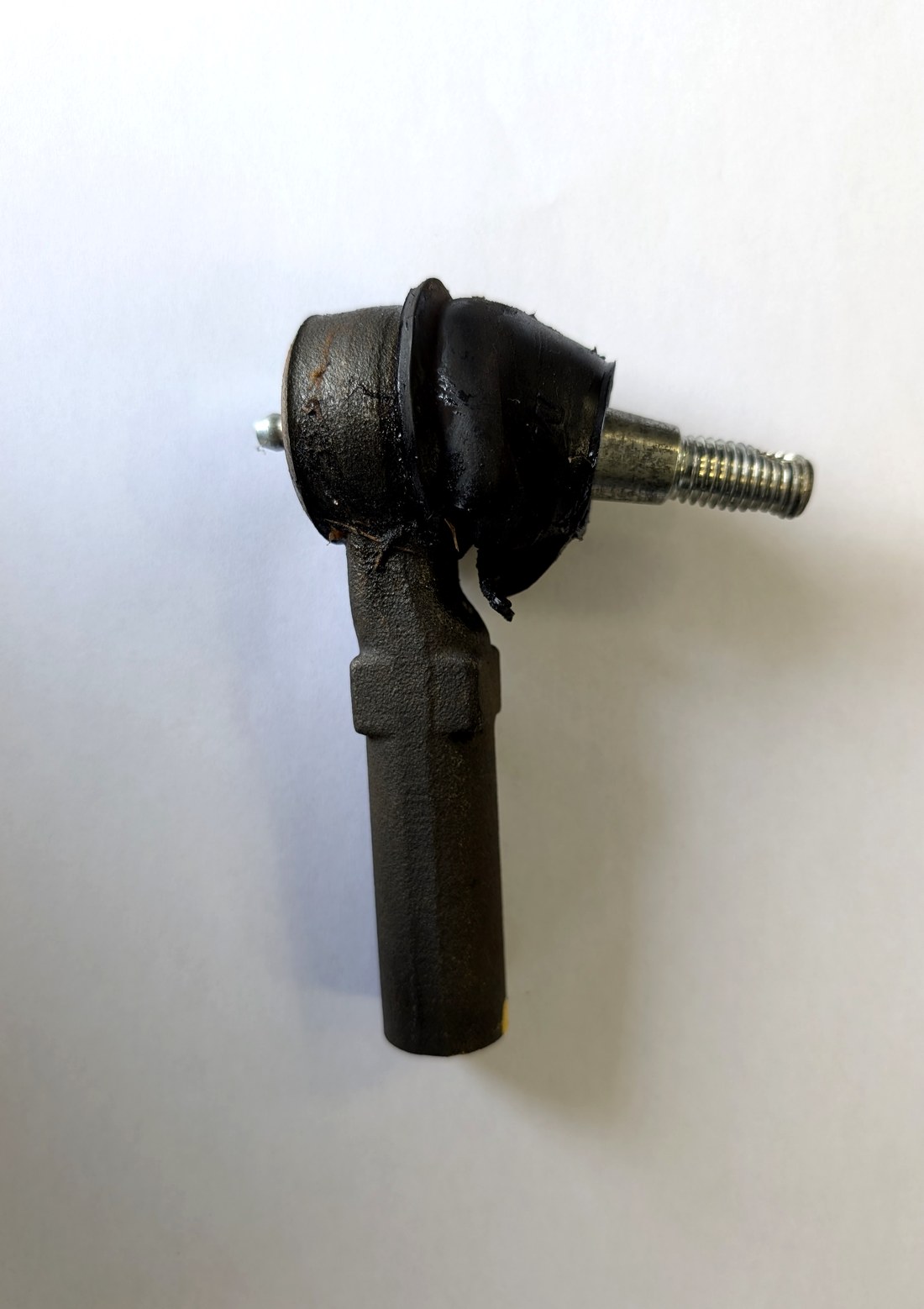 Torn Moog tie rod end dust boot on C5 Corvette showing failed rubber