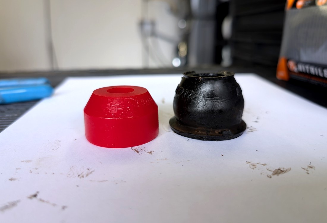 Side by side comparison Energy Suspension polyurethane boot vs failed OEM rubber tie rod boot