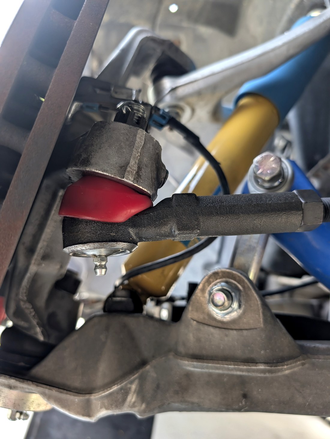 Energy Suspension tie rod boot installed on C5 Corvette viewed from rotor side